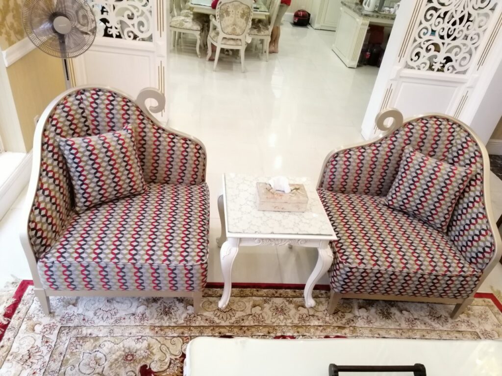 Cặp armchair Ballerina tân cổ điển bọc vải hoạ tiết zigzag nhiều màu, khung bạch kim, đặt hai bên bàn nhỏ trên thảm hoa